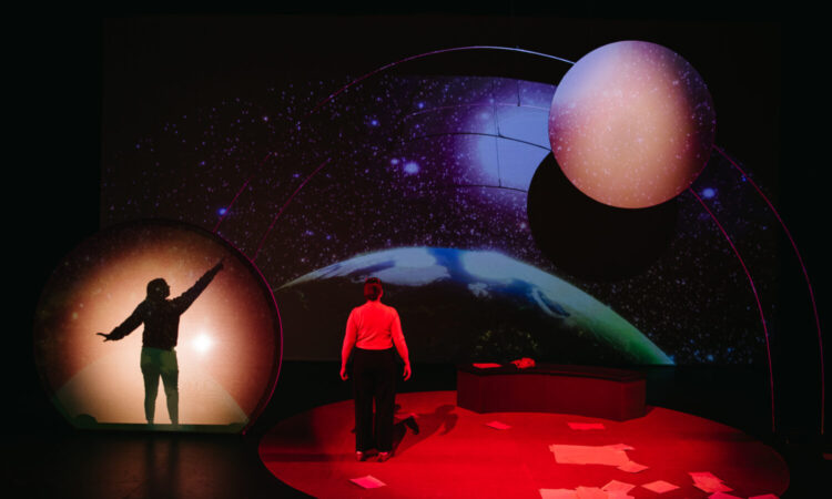 The Space Between Stars by Christine Lesiak. Set Design by Daniela Masellis. Projection Design by Erin Gruber with Rebecca Cypher. Lighting & Costume Design by Skye Grinde. SkirtsAfire 2023. Photo by BB Collective.