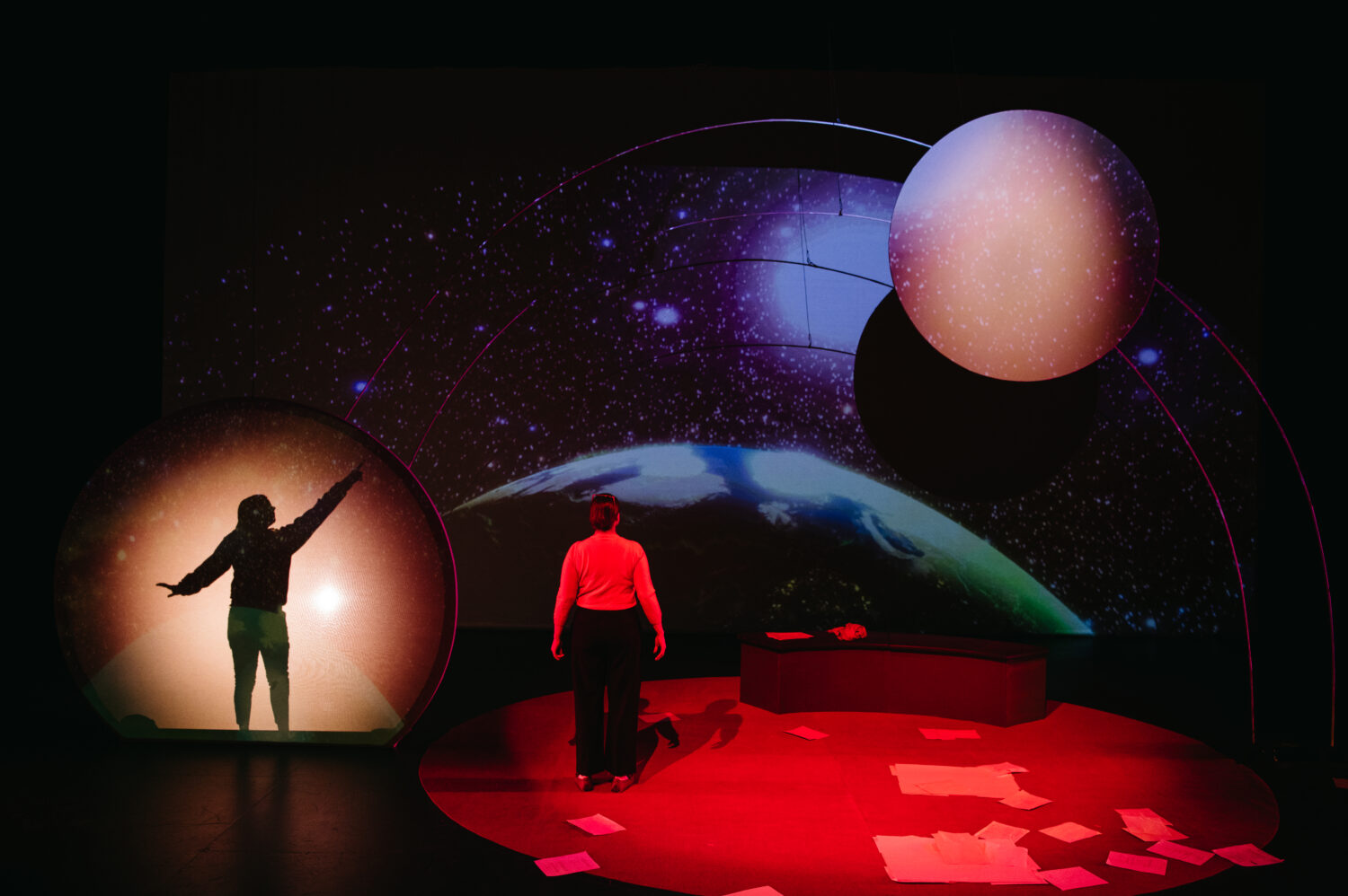 The Space Between Stars by Christine Lesiak. Set Design by Daniela Masellis. Projection Design by Erin Gruber with Rebecca Cypher. Lighting & Costume Design by Skye Grinde. SkirtsAfire 2023. Photo by BB Collective.